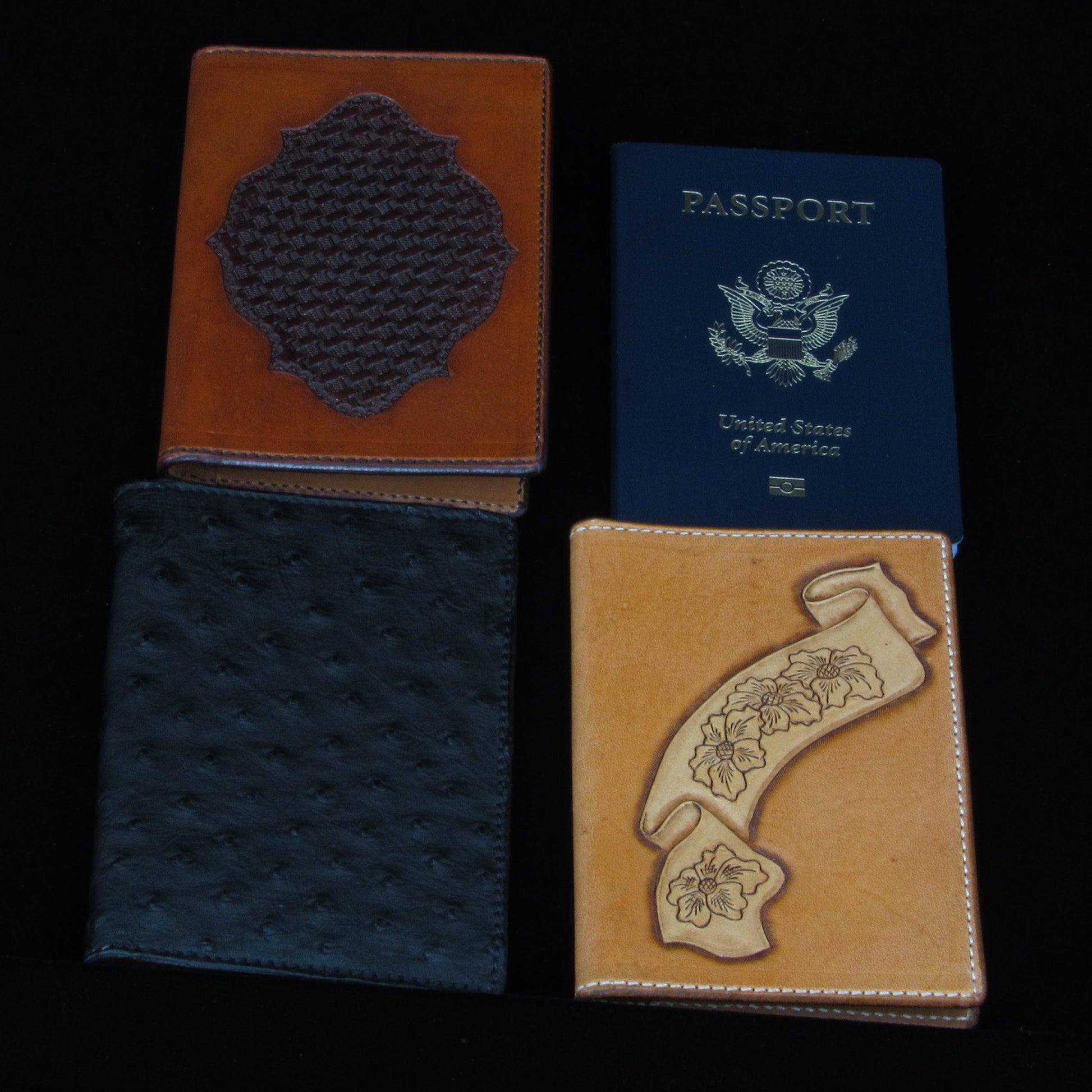 Three passport holders with different designs on a black background