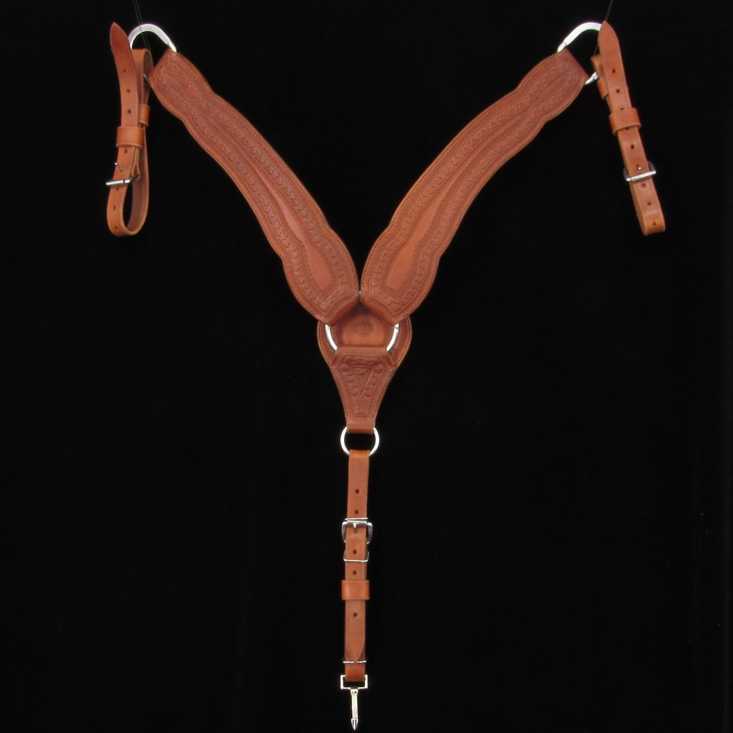 Brown leather saddle breastcollar on a black background